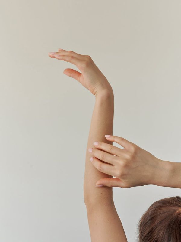 Woman in a graceful yoga pose with amber light accents.